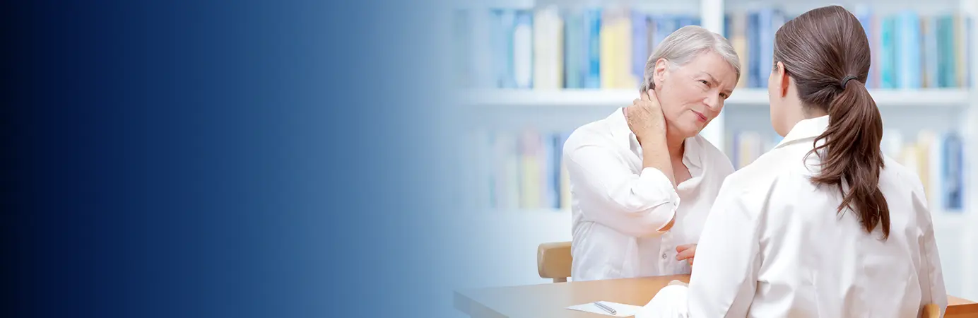 Médica atendendo paciente que está com a mão no pescoço.